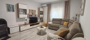 a living room with a couch and a television at Apartment Nereo in Senj