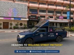 a blue van parked on a street in front of a building at Ease Jomtien by Clubhouse in Jomtien Beach