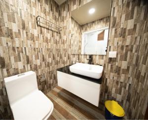 a bathroom with a white toilet and a sink at Villa Crescenta in Ukulhas +33 photos
