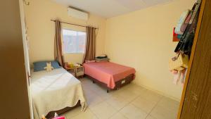 a room with two beds and a window at Casa da Daniella in Conceição do Araguaia