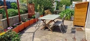 a table and two chairs on a patio at Ty Heole House in Plouézec