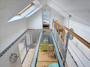 a room with a staircase with a net on it at Ty Heole House in Plouézec