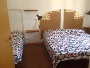 a bedroom with a bed with a comforter at Casa Marel in Stromboli