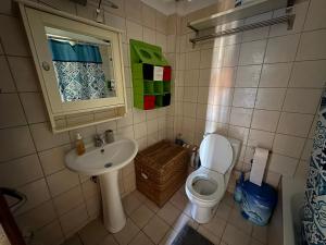 a small bathroom with a sink and a toilet at Afytos Family Apartment in Afitos +14 photos