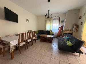 a living room with a couch and a table at Afytos Family Apartment in Afitos