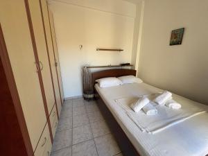 a small bedroom with two beds in a room at Afytos Family Apartment in Afitos