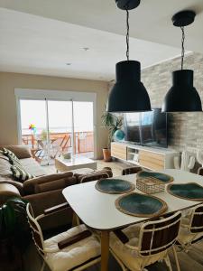 a living room with a table and chairs at Casa Roa in Altea