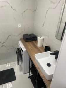 a bathroom with a white sink and a counter at Apartmán Formula Trenčín in Trenčín