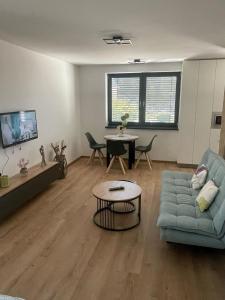 a living room with a couch and a table at Apartmán Formula Trenčín in Trenčín