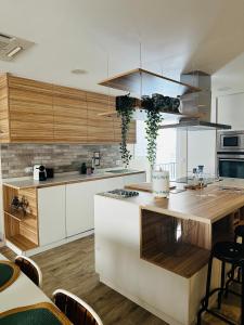 a kitchen with white cabinets and a wooden counter top at Casa Roa in Altea