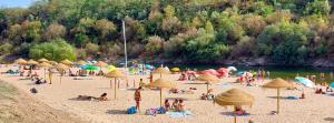 a group of people on a beach with umbrellas at Casa da Maria By Viva a Vida - Alojamentos & Hotels in Constância