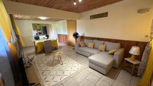 a living room with a couch and a table at La Maison Du Bonheur in Capesterre-Belle-Eau