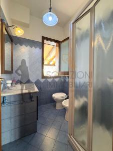 a bathroom with a toilet and a sink and a shower at Villa Calentana in Macari +19 photos