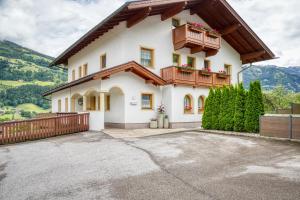 a large white house with a balcony at Appartements Spitaler in Ried im Zillertal