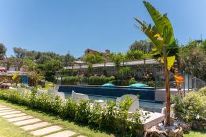 a garden with a swimming pool and a resort at Casale Antonietta in Sorrento