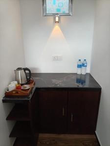 a kitchen counter with two bottles of water on it at Rainforest Nature Resort - Sinharaja in Deniyaya +34 photos