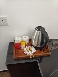 a tea kettle and a plate on a table at Rainforest Nature Resort - Sinharaja in Deniyaya