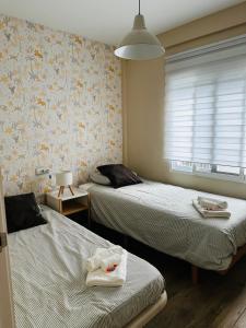 a room with two beds with towels on them at Casa Roa in Altea