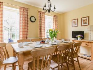 a dining room with a table and chairs at Saltersgate in Pickering +6 photos