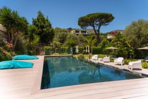 a swimming pool in a backyard with white chairs at Casale Antonietta in Sorrento