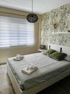 a bedroom with a large bed with towels on it at Casa Roa in Altea +1 photo