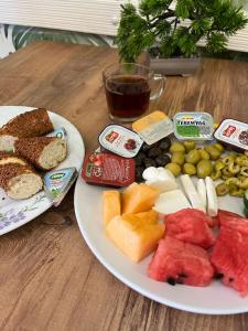 a table with two plates of food and a cup of coffee at Hotel Gazi in Gaziantep