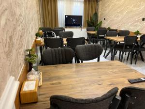 a conference room with tables and chairs and a tv at Hotel Gazi in Gaziantep