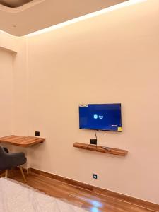 a flat screen tv on a wall in a room at Rishaan Regency in Silchar
