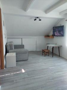 a living room with a couch and a table at Mirni raj in Zlatar