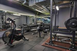 a gym with a bike and weights in a room at Leman Locke in London