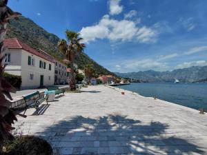 a cobblestone walkway next to a body of water at Muo sea view Garden in Muo