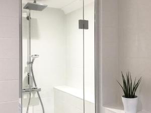 a shower with a glass door in a bathroom at Ebba's Neuk in Beadnell