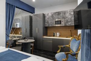 a hotel room with a bed and a kitchen at Maison Astéria in Nice