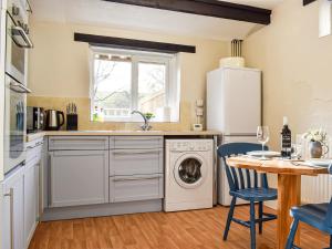 a kitchen with a washer and dryer at The Cottage - Uk35177 in Abbots Bickington