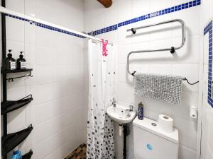 a white bathroom with a sink and a shower at Bloomer's Bothy in Askrigg