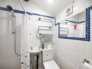 a bathroom with a toilet and a sink at Bloomer's Bothy in Askrigg +1 photo