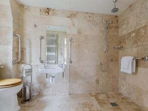 a bathroom with a toilet and a sink at Hungate Garden Cottage in Pickering