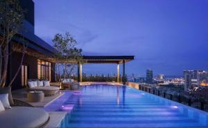 a swimming pool on top of a building with a city skyline at Bichitra Shahi in Kathmandu