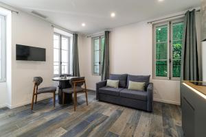 a living room with a couch and a table at Maison Astéria in Nice