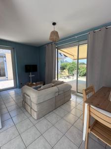 a living room with a couch and a table at La Petite Maison Bénance in Sarzeau +9 photos