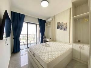 a bedroom with a large bed with blue curtains at Jitendra Pyakuryal in Kathmandu