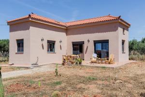 a small house with a patio in front of it at Terra Rossa in Plytra