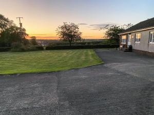 an empty parking lot in front of a house at Seven Seasons in Caldercruix