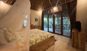 a bedroom with a canopy bed and a window at Amara Giri Ubud View Villas in Ubud +38 photos