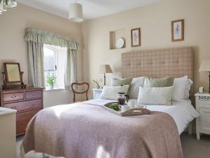 a bedroom with a large bed with a tray on it at Farndale in Pickering