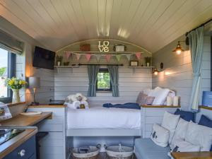 a bedroom in a tiny house with a bed at Morning Mist in Strensall