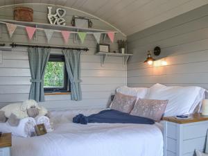 a bedroom with a bed with a teddy bear on it at Morning Mist in Strensall +6 photos