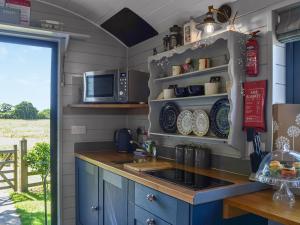 a kitchen with a sink and a microwave at Morning Mist in Strensall