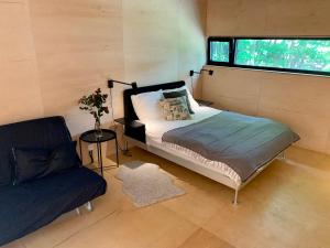 a bedroom with a bed and a chair and a window at Wyszumiane in Staniszów