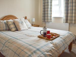 a tray of food on top of a bed at Rudda Farm House - Uk2491 in Staintondale +7 photos